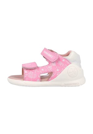 Sandalia rosa para niños con patrones de criaturas marinas blancas, correas ajustables de velcro, suela acolchada y talón reforzado para mayor soporte.