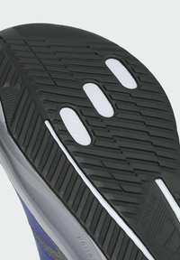 Black rubber shoe sole with textured treads and three white circular accent holes. Features a gray side panel with "ADWEAR" printed.