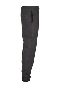 Sorte joggingbukser lavet af blødt stof, med en sidelomme og ribbede cuffs ved anklerne for en tætsiddende pasform. Minimalistisk design.