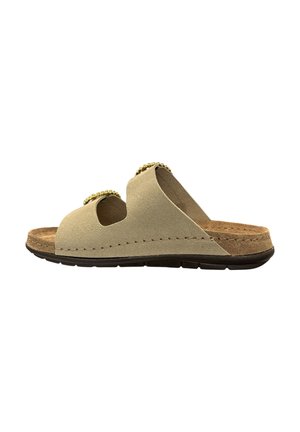 Beige ruskindssandal med to guldlåse-stropper, brun polstret fodseng og sort tekstureret sål, vist fra siden.