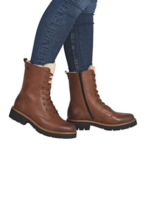 Braune Leder-Stiefeletten mit Schnürung, seitlichem Reißverschluss und Kunstfellfutter. Strukturiertes Obermaterial mit einer robusten schwarzen Gummisohle.