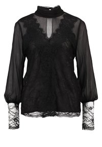 Blouse noire transparente avec un col montant, des accents en dentelle et de longues manches bouffantes. Finitions en dentelle détaillées aux poignets et motif floral en dentelle sur le corps.