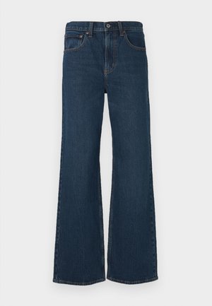 Dunkel gewaschene, aus Denim gefertigte Schlagjeans. Verfügt über fünf Taschen, einen Knopfverschluss und sichtbare Nähte entlang der Säume.