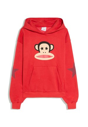 Sweat-shirt à capuche rouge avec un visage de singe dessiné animé aux yeux en forme d'étoile sur la poitrine et des étoiles rouge foncé sur les deux manches.