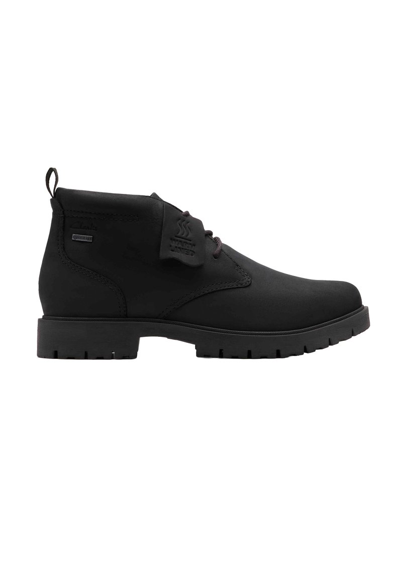 Schwarze wasserdichte Knöchelstiefel aus synthetischem Material, mit runder Zehenkappe, Schnürverschluss und profilierter Gummisohle.