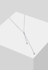 Sølv kædehalssmykke med to sphærisk detaljer, et Y-formet design og en tekstureret overflade. Minimalistisk og elegant udseende.