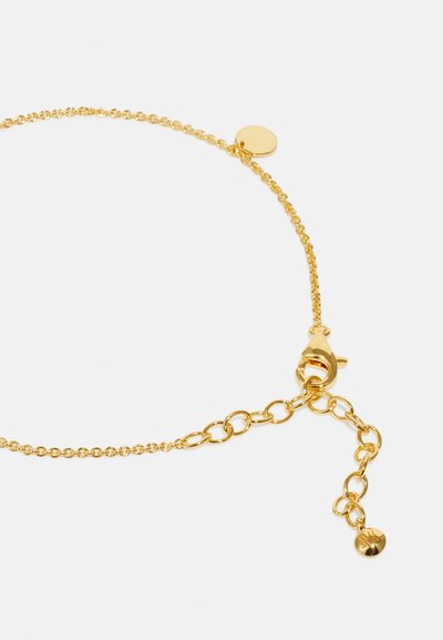 Gold-toned chain bracelet featuring a lobster clasp, round disc accent, and delicate links with a smooth finish.