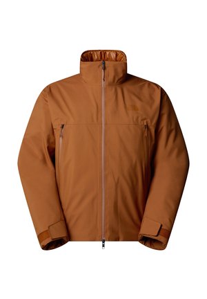 Giacca isolante marrone con colletto alto, chiusura a zip frontale e due tasche con zip. Presenta una superficie liscia e un sottile dettaglio del logo.