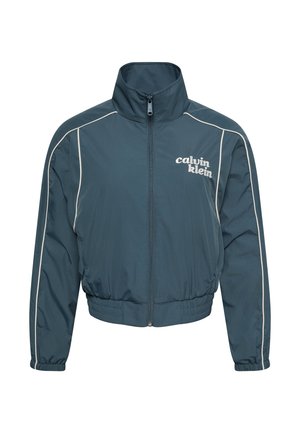 Chaqueta verde azulado oscuro con cremallera y cuello alto, ribetes blancos a lo largo de las mangas, cintura y puños elásticos, y logo "calvin klein" en el pecho izquierdo.
