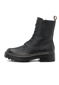 Botte noire en cuir à la cheville avec semelle épaisse à relief, fermeture à lacets à l'avant et languette en cuir brun à l'arrière, présentée de profil droit sur fond blanc.