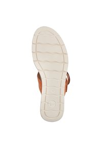 Sandal in pelle marrone con suola in gomma bianca caratterizzata da un motivo a scanalature ondulate, etichetta di dimensione visibile "37" e design con cinturini aperti.