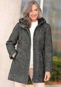 Halsdoek met een zwart-wit houndstooth patroon, voorzien van een capuchon, voorkennis en een rechte snit, met een gestructureerde stofafwerking.