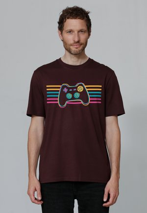 Maroon cotton T-shirt featuring a graphic of a game controller with colorful stripes in blue, pink, and yellow. Short sleeves and crew neck.