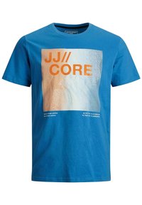 T-shirt di cotone blu con una grande grafica arancione e bianca con il testo "JJ//CORE," e le coordinate geografiche in stampa più piccola sotto.