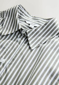 Gray and white striped button-up shirt with a collared neck, made from smooth fabric; features white buttons and a tag labeled "NEXT."