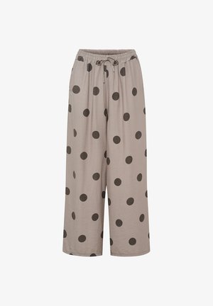 Beige bukser med brede ben, sorte prikker, elastisk linning og snøre, vist på hvid baggrund.