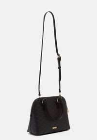 Černá kabelka s texturovaným hexagonálním vzorem, zlatým kováním, dvěma krátkými uchy a nastavitelným dlouhým popruhem. Zapínání na zip na vrchu.