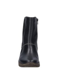 Bottes en cuir noires à la cheville avec une finition lisse, fermeture éclair sur le côté et coutures contrastées le long des seams. Semelle en caoutchouc basse.