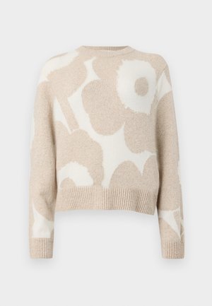Pull en marron clair avec un motif floral blanc, design court, ourlet côtelé et manches longues, fabriqué en matière tricotée douce.