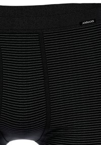 Black striped underwear made from a soft, stretchy material. Features a black elastic waistband with a label and subtle vertical stripe pattern.
