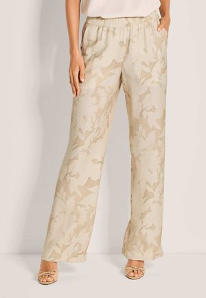 Light beige floral-patterned trousers with an elastic waistband and side pockets; wide-leg design with a textured fabric.