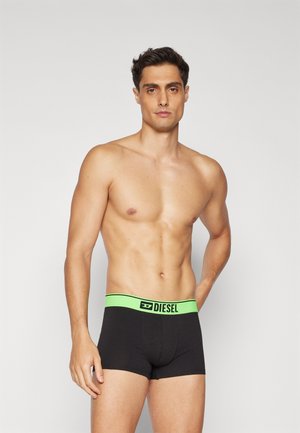 Black boxer briefs with a bright green elastic waistband featuring the Diesel logo. Made of smooth fabric, they have a snug fit and short legs.