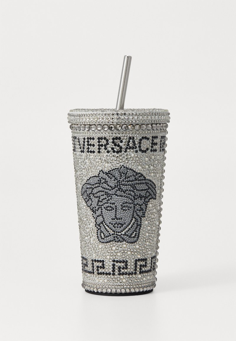 Silver bling cup with rhinestone embellishments, featuring a prominent Versace logo and Medusa head design, topped with a metal straw.