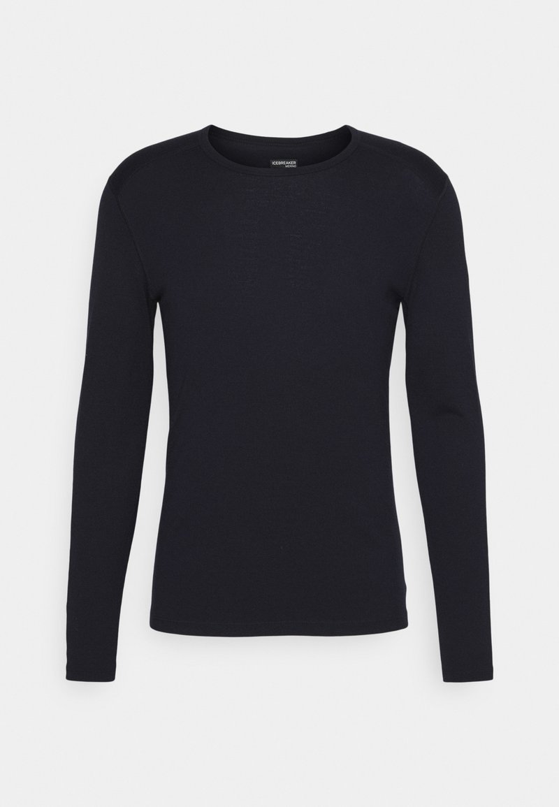 T-shirt à manches longues et col rond en bleu marine foncé. Confectionné dans un tissu lisse et extensible, avec une silhouette ajustée et des détails de couture subtils.