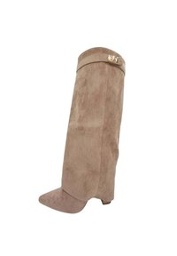 Botte en suède beige montée jusqu'au genou avec un bout effilé et un talon block modeste. Présente un accent doré près du haut. Texture douce sur l'ensemble.