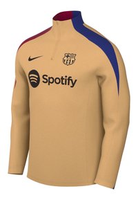 Haut d'entraînement à manches longues beige du FC Barcelone avec des rayures marron et bleues, logo Nike et sponsor Spotify sur la poitrine.
