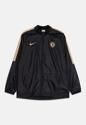 Černá bunda Nike se zlatými akcenty, vysokým límcem, zipovým zapínáním, bočními kapsami a logem Chelsea FC na hrudi.