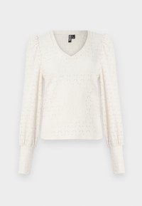 Vit stickad pullover med V-ringning, långa puffärmar och diamantramönster. Har ribbade ärmslut och en något kortare passform.