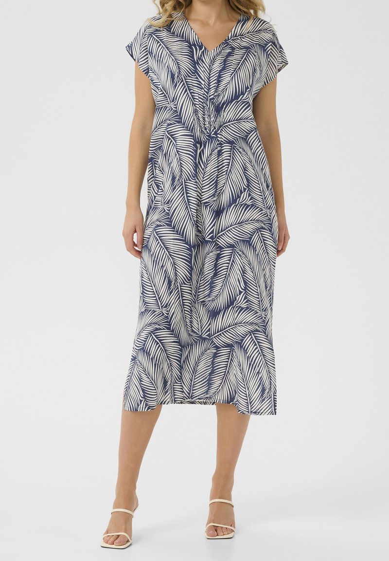 Robes bleu marine avec motif de feuilles blanches, manches courtes à volant, décolleté en V et ourlet jusqu'au genou. Fabriquée en tissu léger.