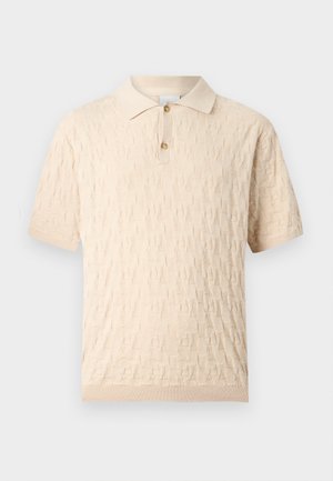 Beige short-sleeve polo shirt with textured geometric pattern and two-button placket, ribbed collar and cuffs.