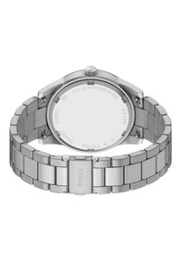 Montre Fossil en acier inoxydable avec un fini poli et brossé. Boîtier rond, bracelet en métal, logo gravé et résistance à l'eau jusqu'à 5 ATM.
