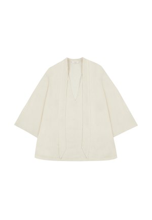 Top leggero in lino di colore bianco sporco. Caratterizzato da maniche ampie, scollatura a V profonda e un design con apertura frontale con cuciture verticali. Tessuto liscio.