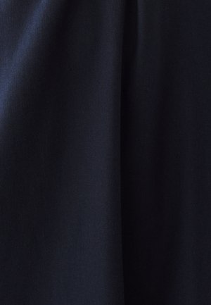 Tmavo námornícka modrá tkanina s jemnými vertikálnymi záhybmi a hladkým, mierne textúrovaným povrchom pod rozptýleným osvetlením.