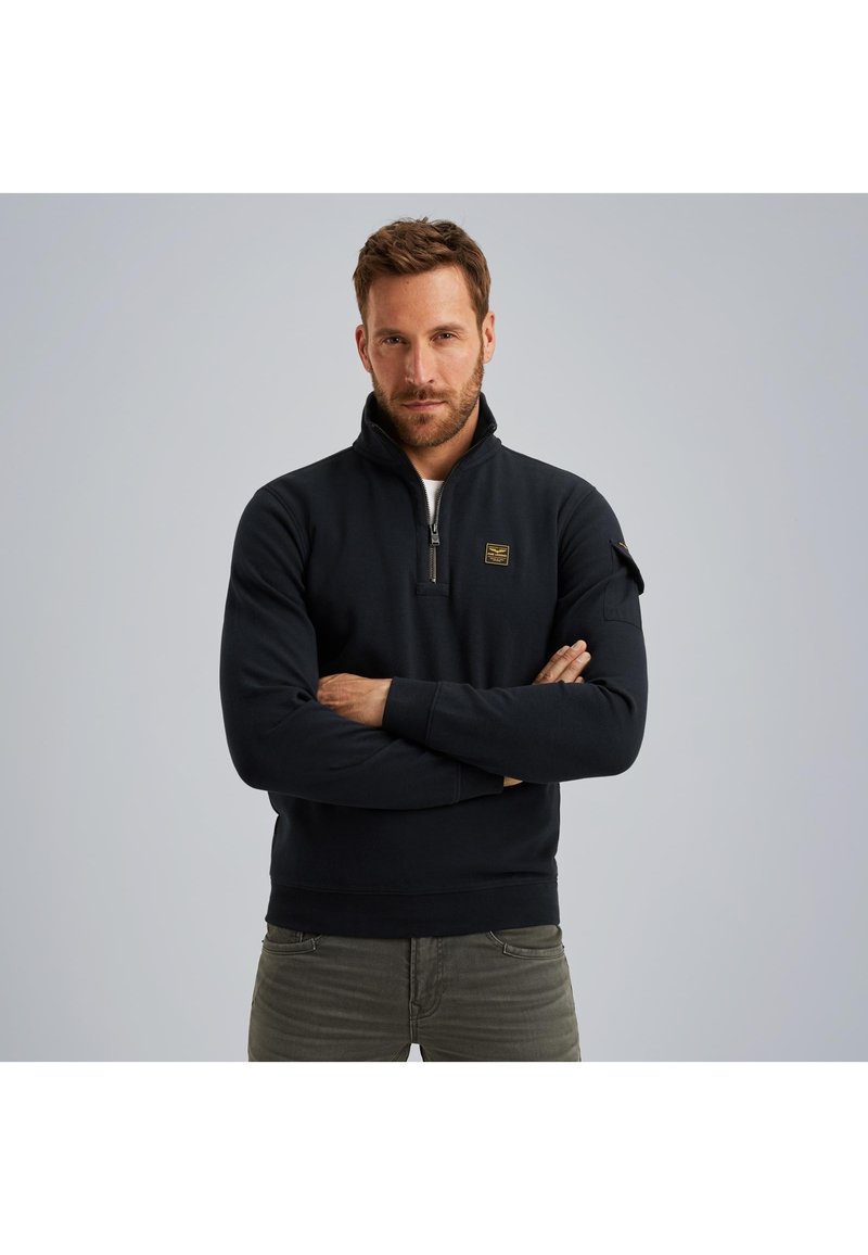 Zwart zip-up fleece pullover met hoge kraag, met een klein logo op de borst en geribbelde mouwen. Gestructureerde pasvorm, zachte textuur.