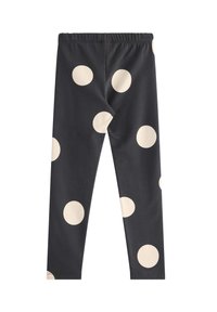 Zwarte leggings met grote crèmekleurige stippen. Voorzien van een elastische tailleband. Gemaakt van een zachte, rekbare stof.