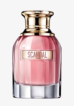 Glass perfume bottle with pink liquid, gold cap, and label reading "SCANDAL" centered on front.