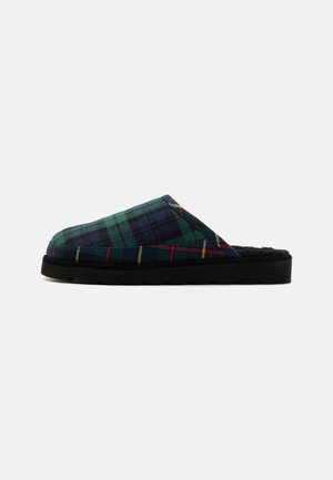Plaid slippers with a green, blue, and yellow pattern, featuring a black rubber sole and a soft interior lining for comfort.