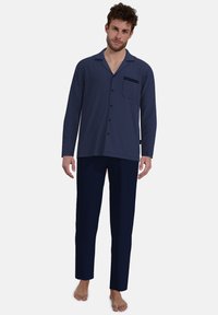 Men's pajama set featuring a navy blue, patterned top with a pocket and solid navy pants, made from lightweight fabric, designed for comfort.