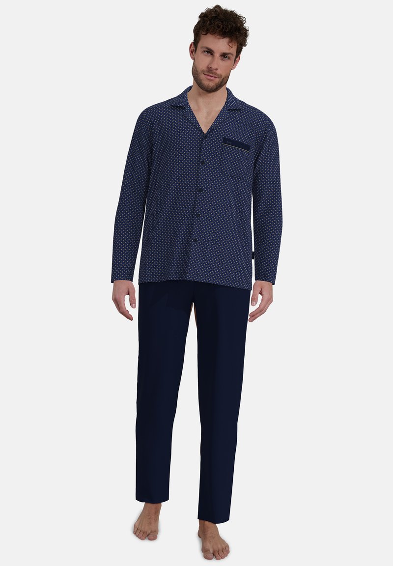 Men's pajama set featuring a navy blue, patterned top with a pocket and solid navy pants, made from lightweight fabric, designed for comfort.