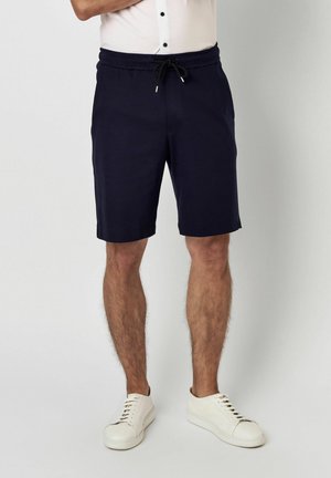 Marineblaue Baumwollshorts mit elastischem Bund, verstellbarem Kordelzug und Seitentaschen. Verfügt über einen geraden Saum und eine taillierte Passform.