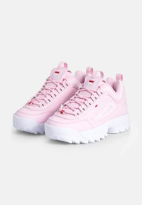 Par de zapatillas FILA rosas con suelas blancas gruesas, diseño de cordones y acentos de logo en las lenguas y los lados, inclinadas hacia la izquierda sobre un fondo blanco.