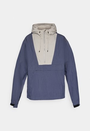 Light gray and navy blue hooded windbreaker jacket with half zipper and adjustable drawstrings, displayed on a white background.