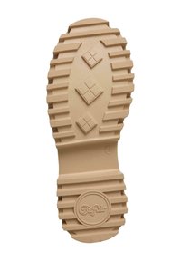 Suela de un zapato en goma beige clara, con un patrón acanalado, acentos en forma de diamante y un logotipo circular en el centro inferior.