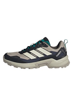 Beige, marineblaue und türkisfarbene Adidas Terrex Trailrunning-Schuhe mit robuster Sohle und weißen Streifen an der Seite.