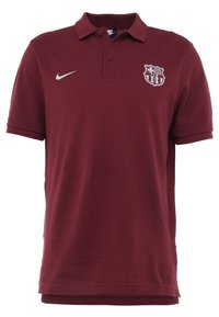 Bordeauxrotes Nike-Polohemd mit Kragen, kurzen Ärmeln und strukturiertem Stoff. Verfügt über ein weißes Logo und ein Vereinswappen auf der Brust.