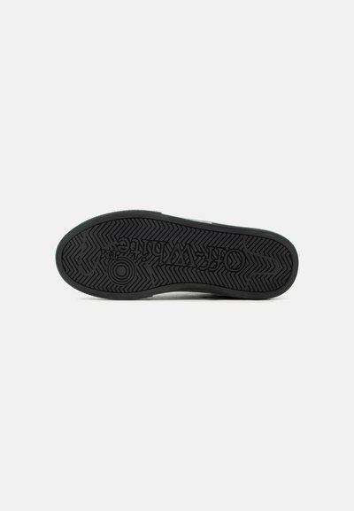 Semelle de chaussure en caoutchouc noir avec motif en Chevron et logo "Off-White" embossé au centre.